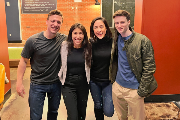 Fellows smiling and posing in an indoor setting