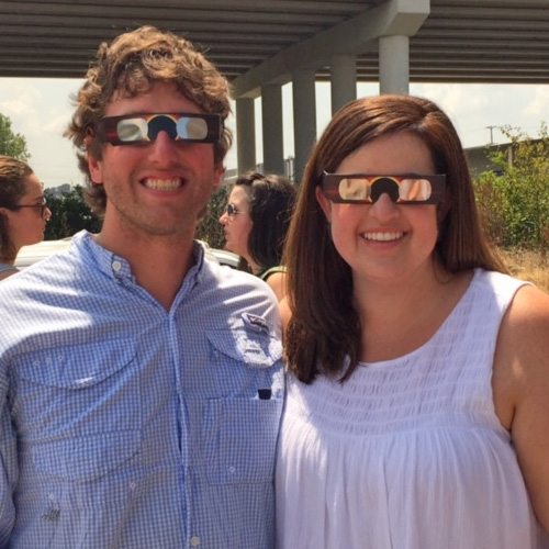 Two residents with eclipse glasses
