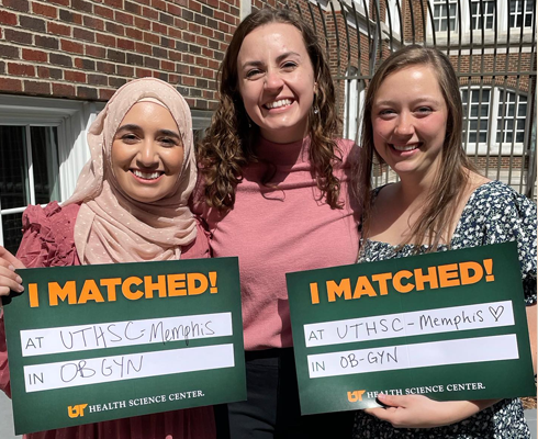 Residents holding match day signs