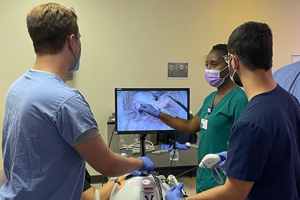 Residents looking at a monitor in an operating room
