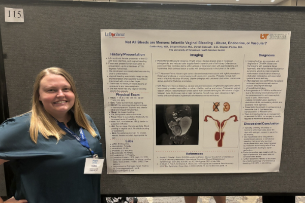 Resident standing before a poster presentation