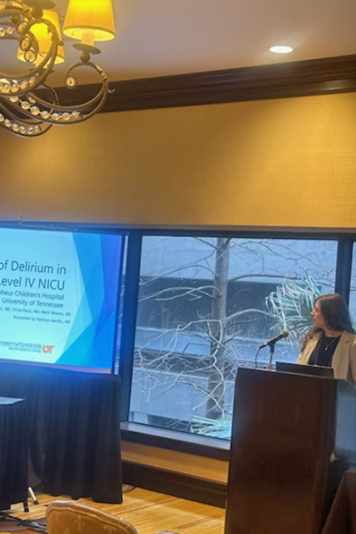 Presenter standing at a podium during a conference