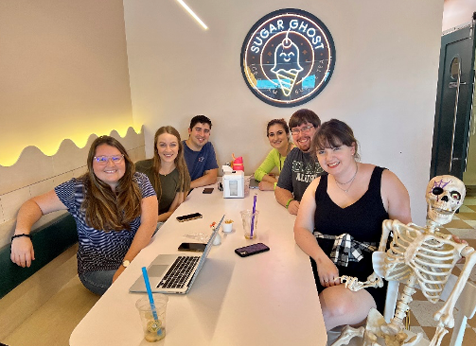Wellness committee sitting at a table with a skeleton