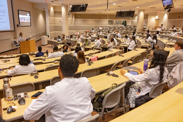 Pharmacy students in large classroom.