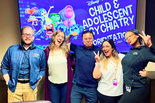 Fellows indoors in front of a child psych screen