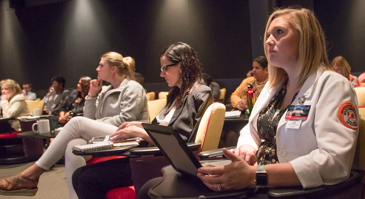 Attendees of the conference listening to a speaker