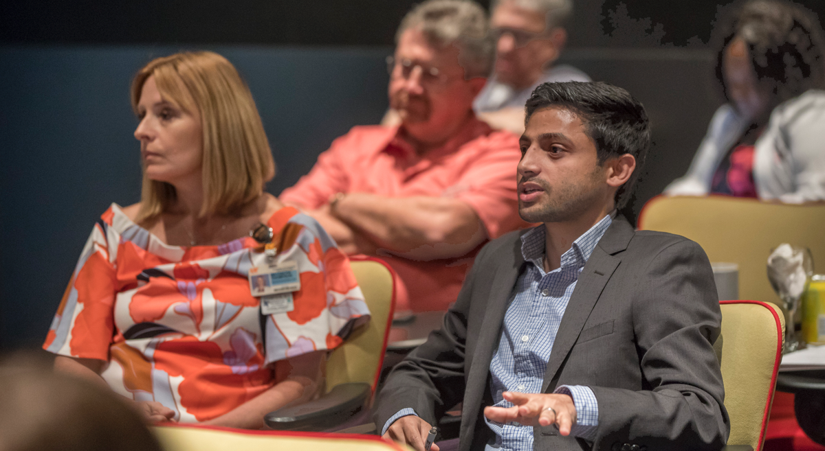 Attendees of the conference listening to a speaker