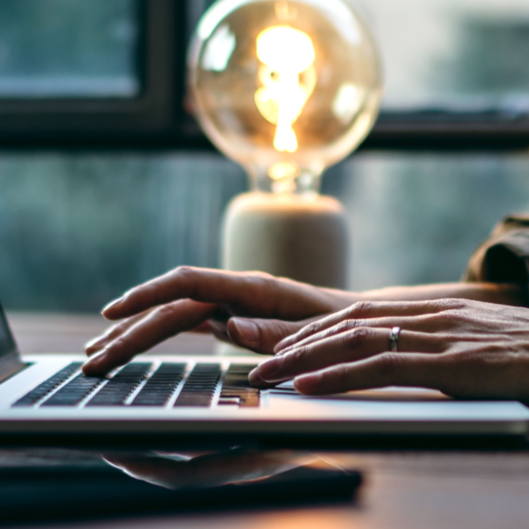 Photo of hands typing on a laptop keyboard