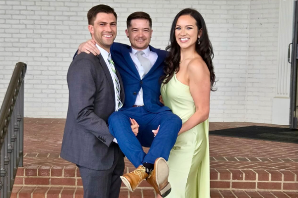 Residents clowning around at graduation by carrying one resident