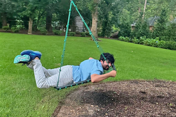 Resident riding in a tree swing